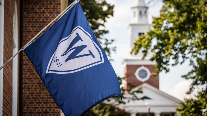 A flag with a W and year 1841 raised on the Williston campus