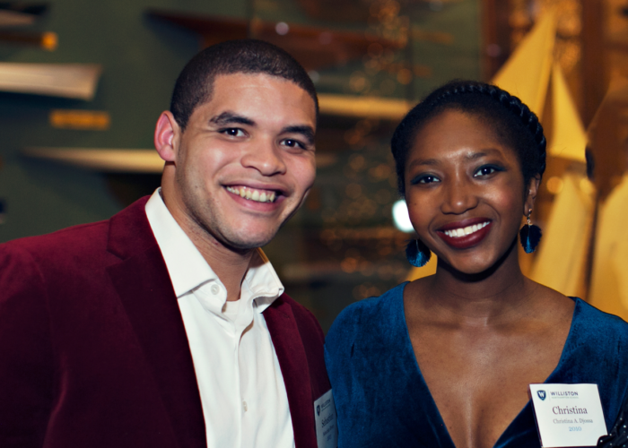 Two alumni posing at an event